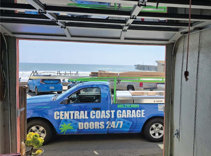 cory lewis truck performing emergency 24-7 garage opener service on a damaged unit
