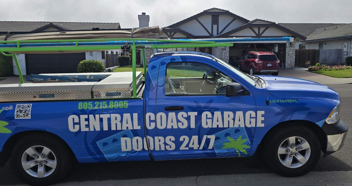 A branded Central Coast Garage Doors 24/7 mobile service truck parked at a residential property, ready to provide expert garage door repair with hero discount for a local homeowner.